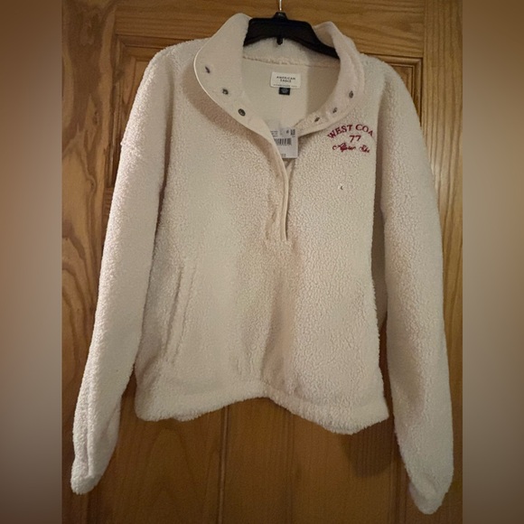 American Eagle Outfitters Tops - American Eagle Cream Fleece Pullover with Red Embroidery Sz Large, NWT!